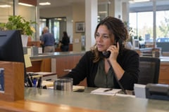Receptionist on a desk phone call at a front desk